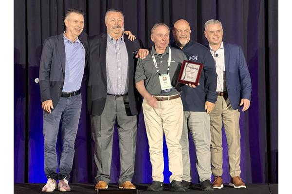 Ray Mancini Jr., Bill Prescott, Brian Green, all of UCX, present the Retailer of the Year award to Floor and Home Inc. owner Tony Sicilia.
